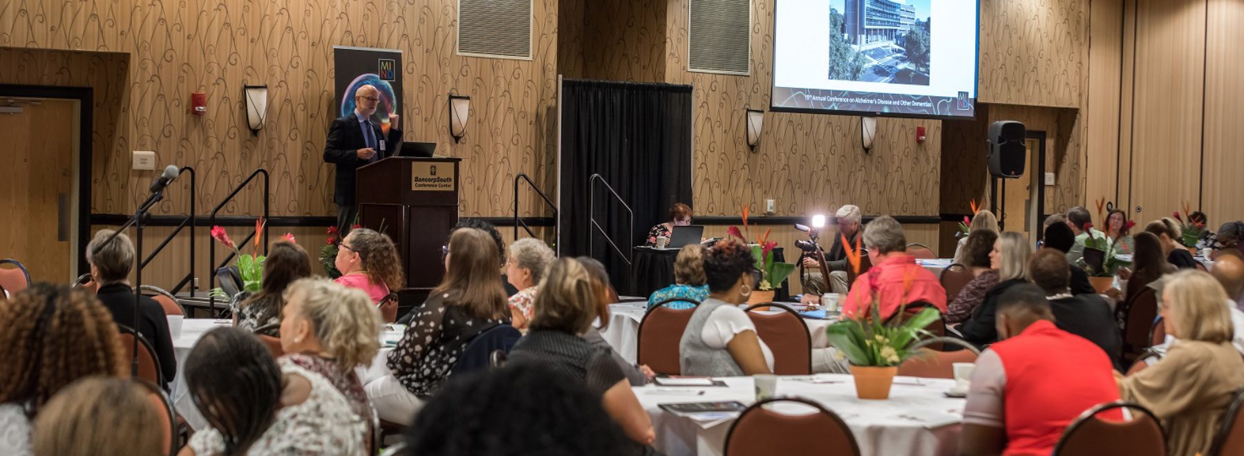 A speaker addresses a group of people